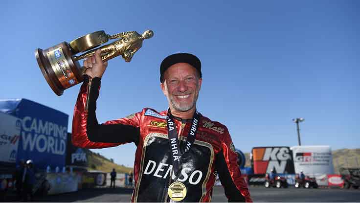 Pro Stock Motorcycle racer Matt Smith holding Wally Trophy.