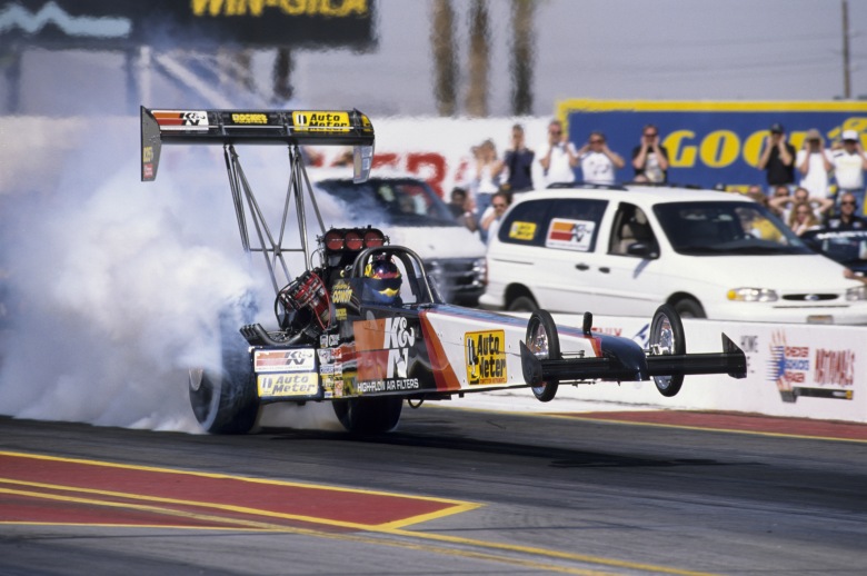 Second-generation Aussie nitro pilot Andrew Cowin showed the power and fury of a Top Fuel dragster by simultaneously wheelstanding and smoking the rear tires on this launch at the 1999 Phoenix event. 