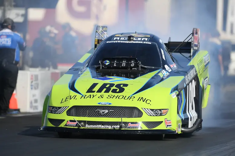 Tim Wilkerson's Funny Car explodes in a fireball in round one—but still advances