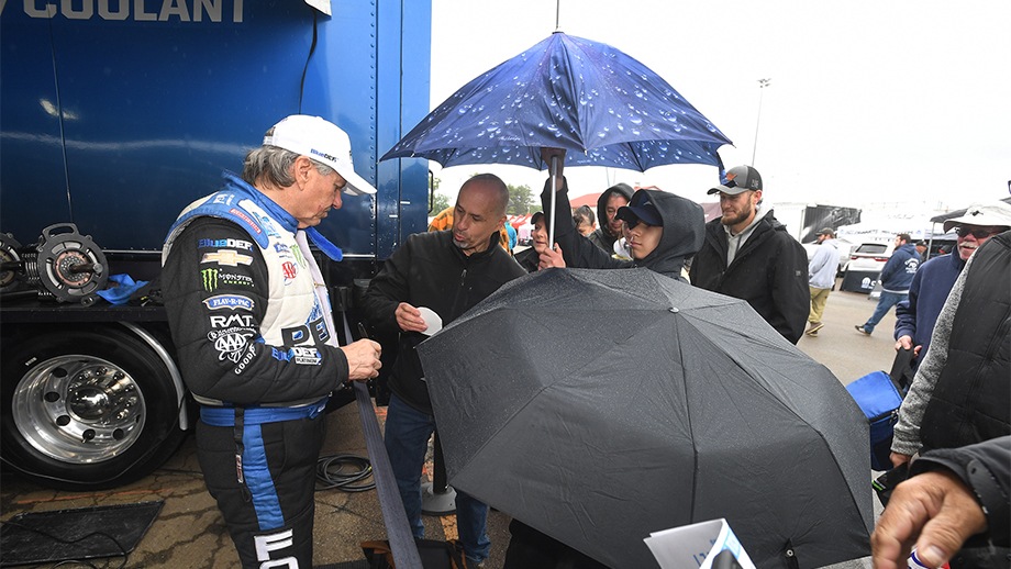 John force with fans during rain delay
