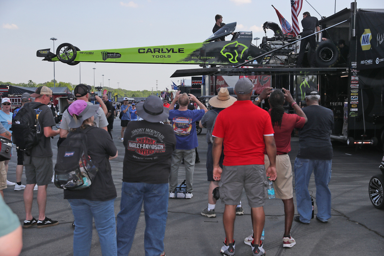 Fans watch as the Carlyle Tools/Ron Capps Motorsports dragster gets unloaded