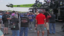 Fans watch as the Carlyle Tools/Ron Capps Motorsports dragster gets unloaded